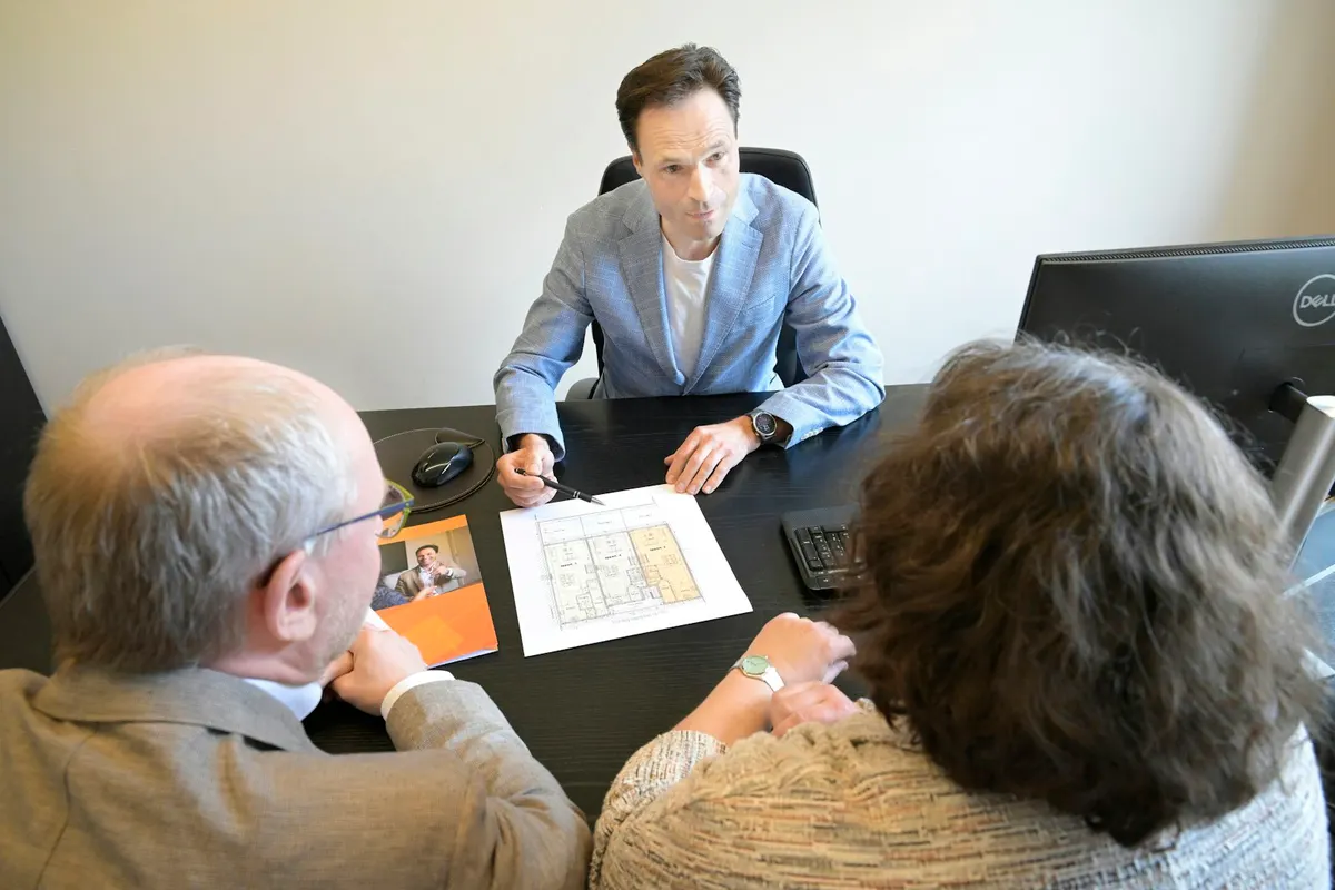 Close-up of a client conversation with documents on the table