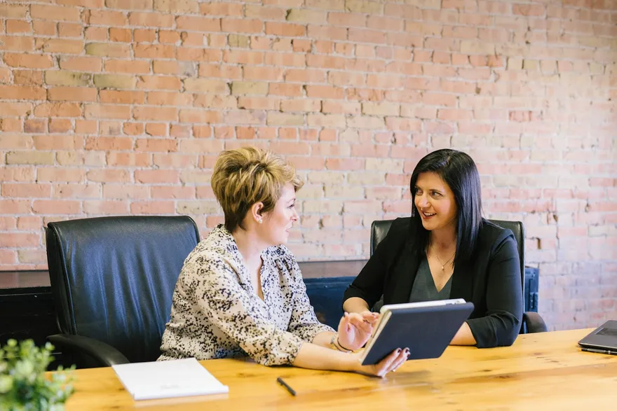 Advisor smiling and explaining health coverage options to a client